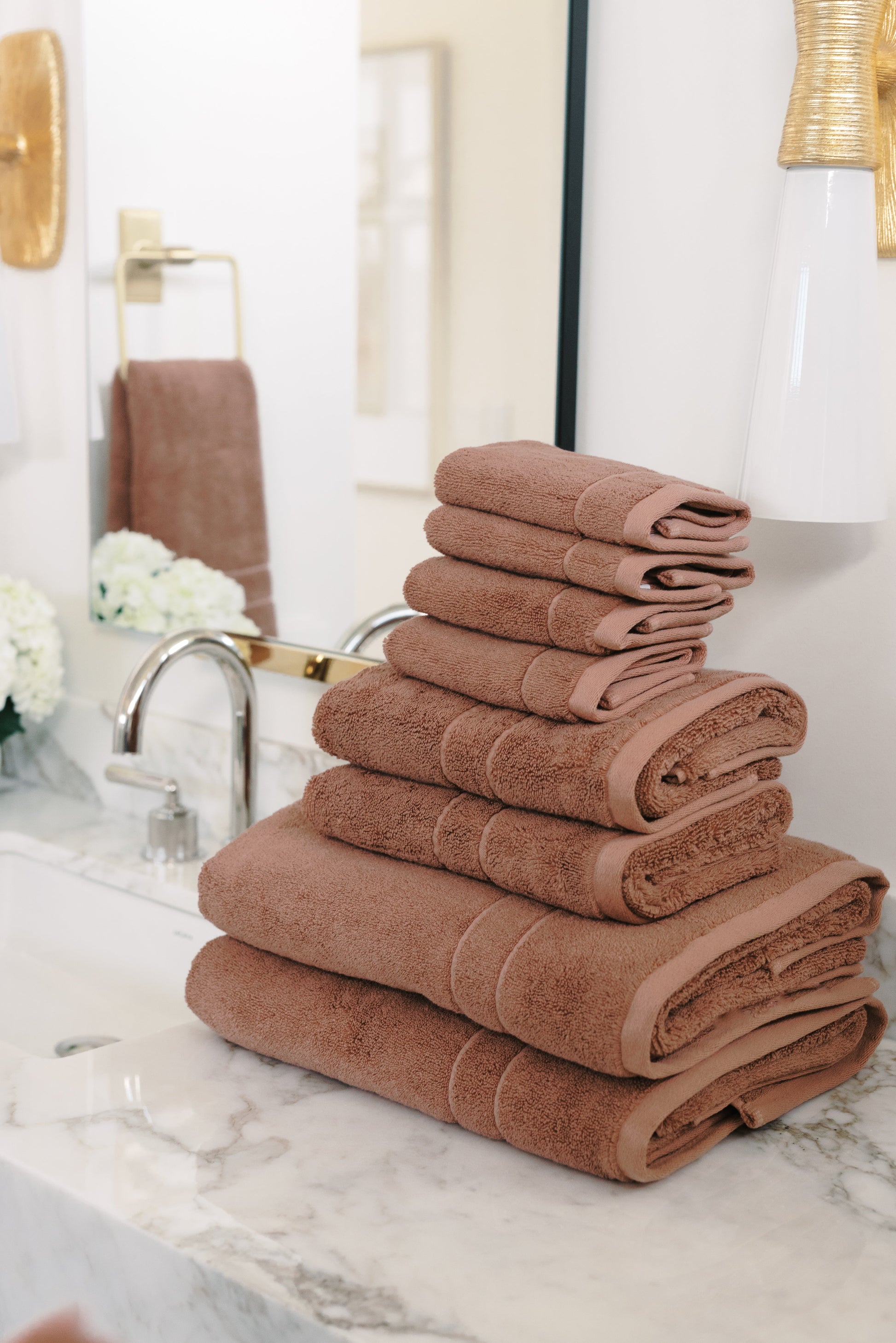 Premium Plush Bath Towel Set in the color Clay. Photo of Clay Premium Plush Bath Towel Set taken in a bathroom featuring white backsplash tile |Color:Clay